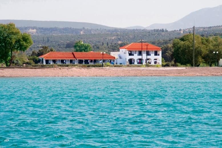a house on the shore of a body of water at Ilias Apartments in Methoni