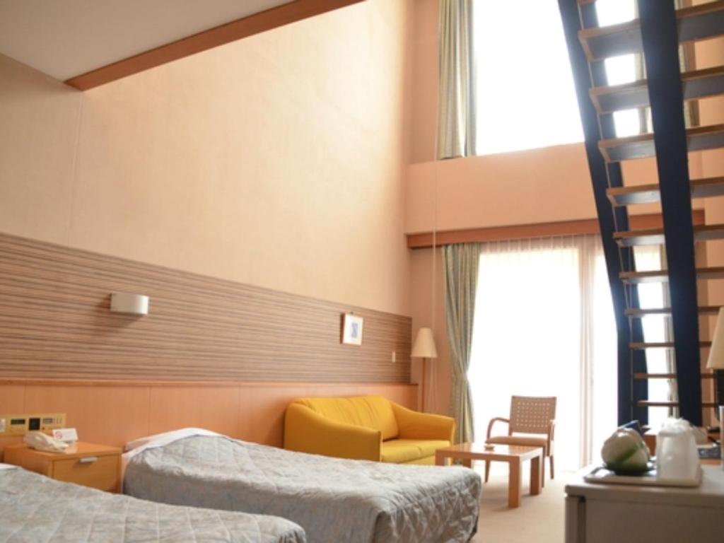 a hotel room with two beds and a ladder at Bokkai Onsen Seaside Villa Bokkai - Vacation STAY 69010v in Shika