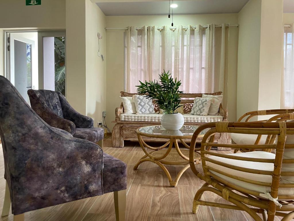 a living room with a couch and a table and chairs at Alka's Paradise Guest House and Lodging in San Andrés