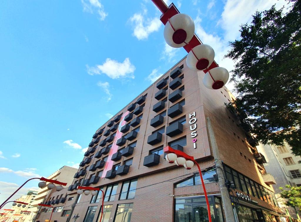 a tall building with a hotel sign on it at 360 Liberdade in Sao Paulo