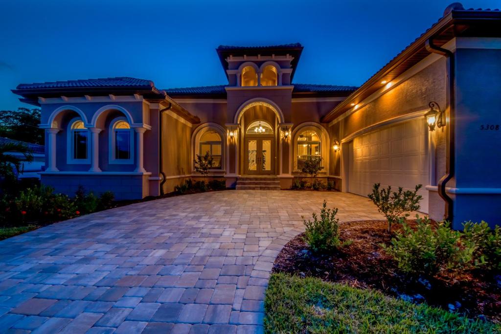 a large house with a driveway at night at Villa Mayfair, Cape Coral in Cape Coral