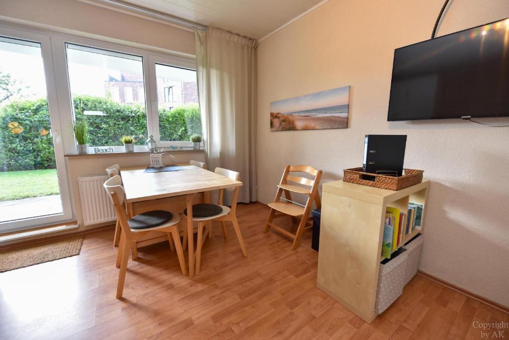 ein Wohnzimmer mit einem Tisch und einem TV in der Unterkunft Haus Kehrwieder Appartement KEHR8 in Cuxhaven