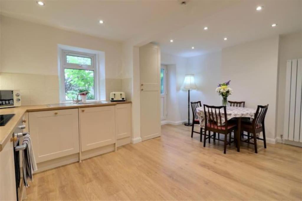 a kitchen and dining room with a table and chairs at Four Double Bedroom Home - Free parking and Wi-Fi in Horsforth