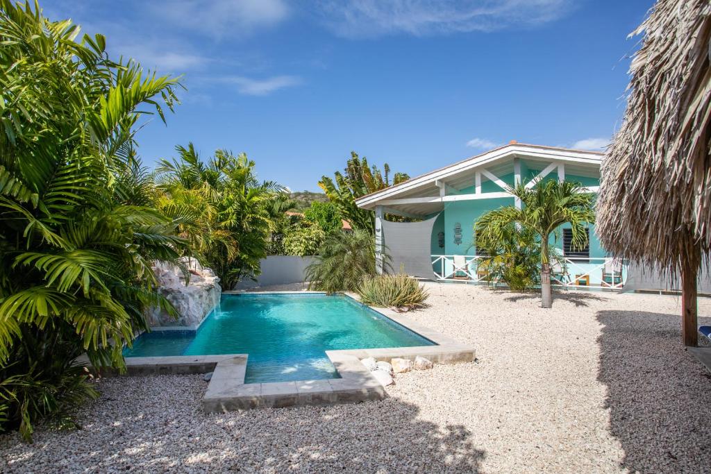 a swimming pool in the backyard of a house at Paradise Apartments - Curacao in Fontein