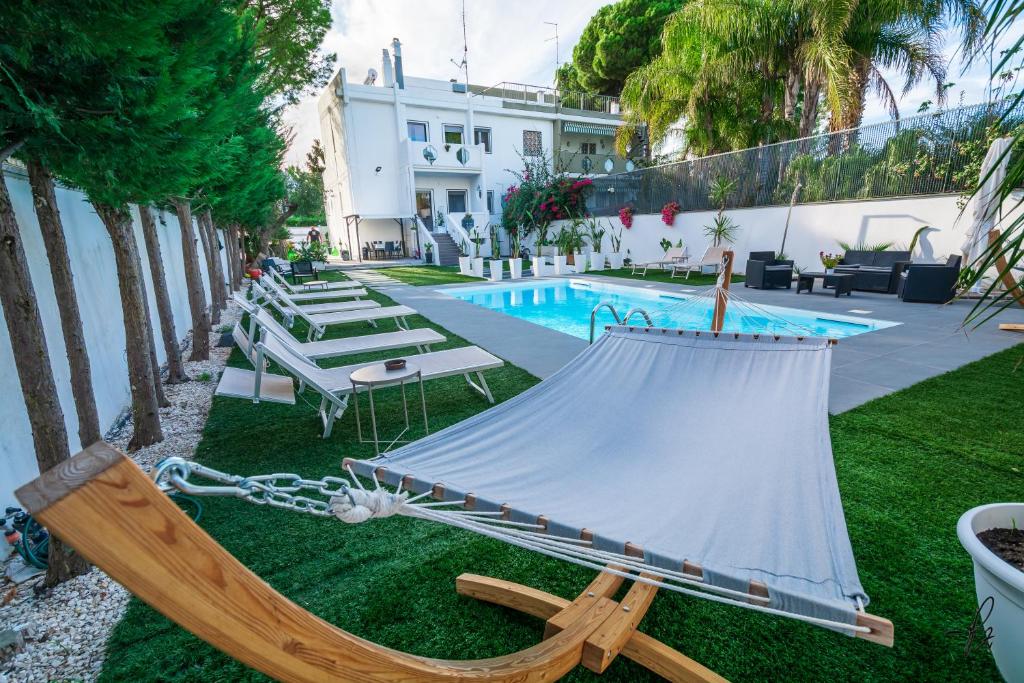 a hammock on the grass next to a pool at B&B Magnolia Bari in Bari