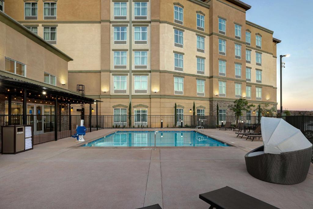 a large building with a swimming pool in front of a building at Homewood Suites By Hilton Santa Clarita/Valencia, Ca in Santa Clarita