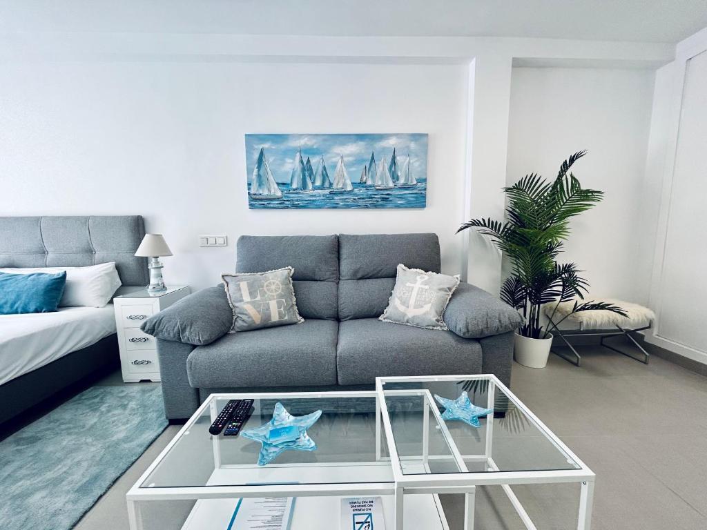 a living room with a couch and a coffee table at Mare Apartments Marbella in Marbella