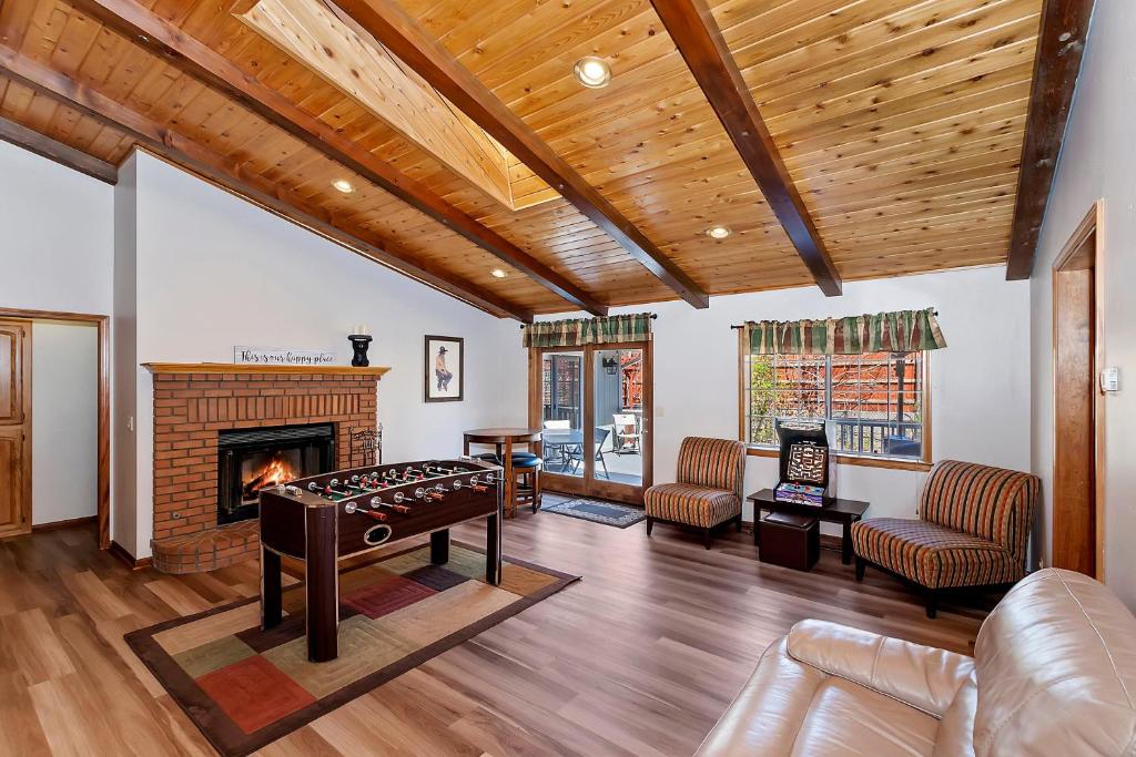 a living room with a table and a fireplace at 118 - Pinecrest Getaway in Big Bear Lake