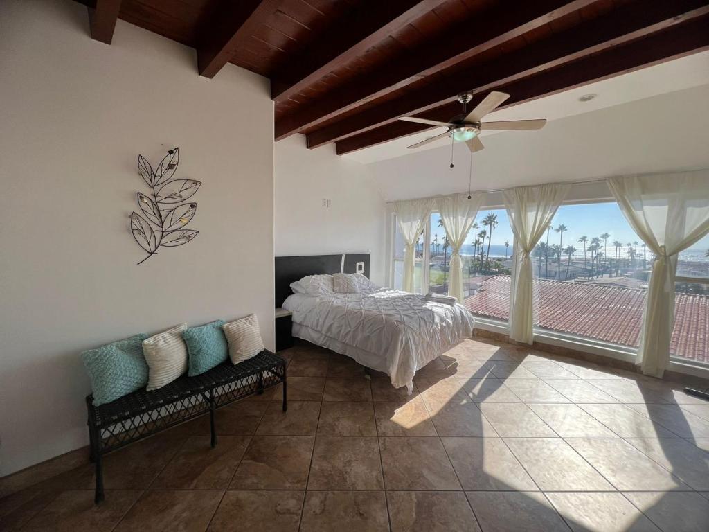 a bedroom with a bed and a ceiling fan at Beachfront Bungalow Rosarito Beach in Rosarito
