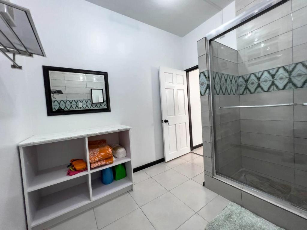 a bathroom with a shower and a mirror at Chalet Belizomi Tropical Villas Studio Villa #3 in Gros Islet