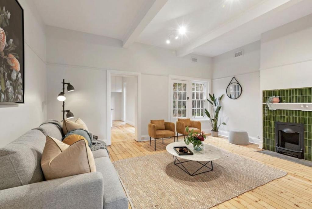 uma sala de estar com um sofá e uma lareira em NEWLY RENOVATED LARGE 3.5 BDRM HOUSE! BEST OF MELB em Melbourne