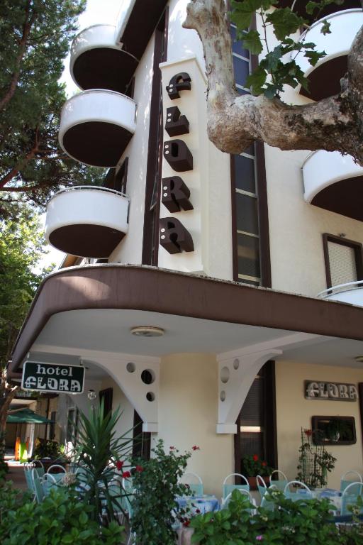 a group of chairs sitting outside of a building at Hotel Flora in Bellaria-Igea Marina