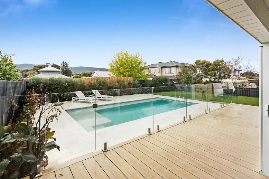 a swimming pool with a fence around it on a wooden deck at The Family Beachside Escape by Ready Set Stay - HOUSE & GUEST HOUSE in Rosebud