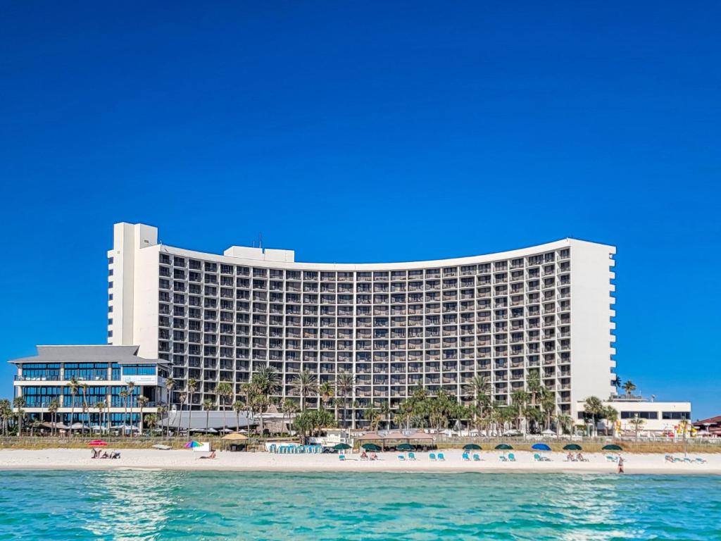 a hotel on the beach next to the ocean at Holiday Inn Resort Panama City Beach - Beachfront, an IHG Hotel in Panama City Beach