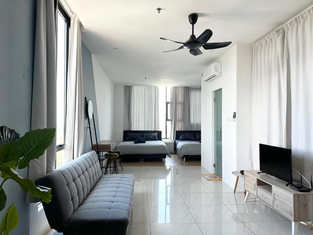 a living room with a couch and a ceiling fan at ITCC Manhattan Suites by Stay In 5-6pax in Donggongon