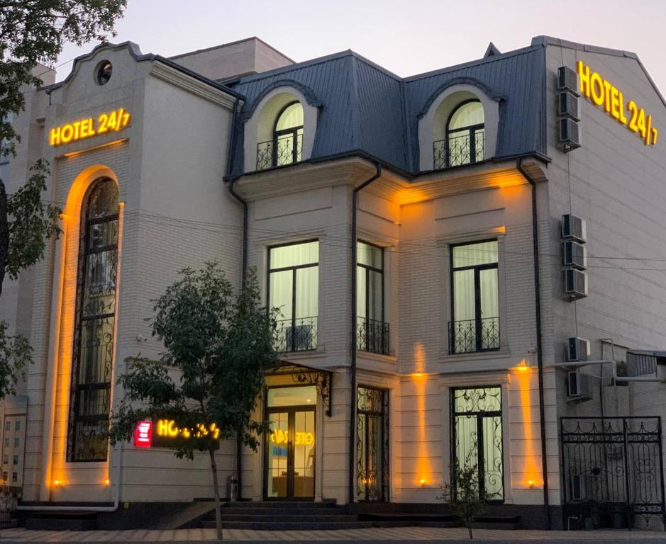 a large white building with yellow lights on it at Airport Hotel 24 in Tashkent