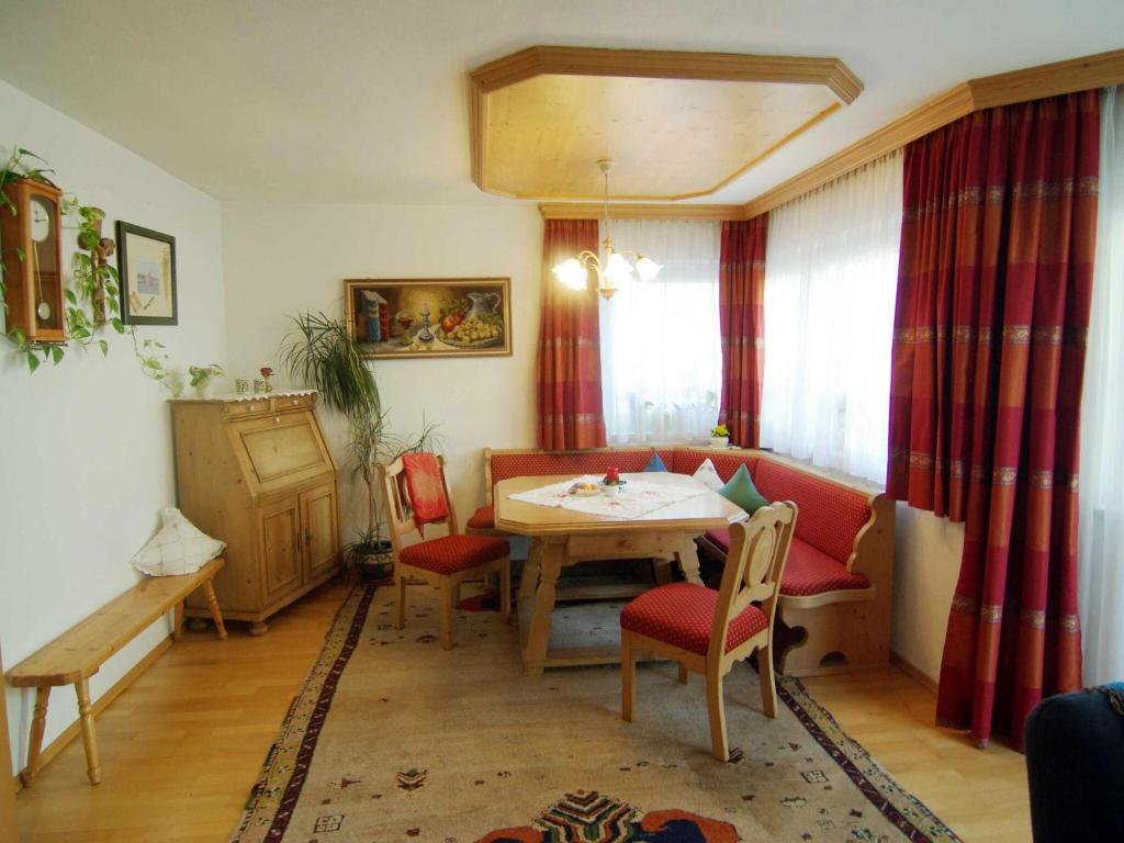 a living room with a table and red chairs at Great holiday home in Hippach with sunny terrace in Hippach