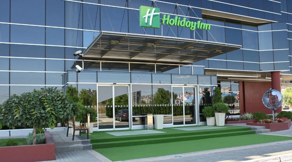 a building with a hudsonium sign on it at Holiday Inn Belgrade, an IHG Hotel in Belgrade