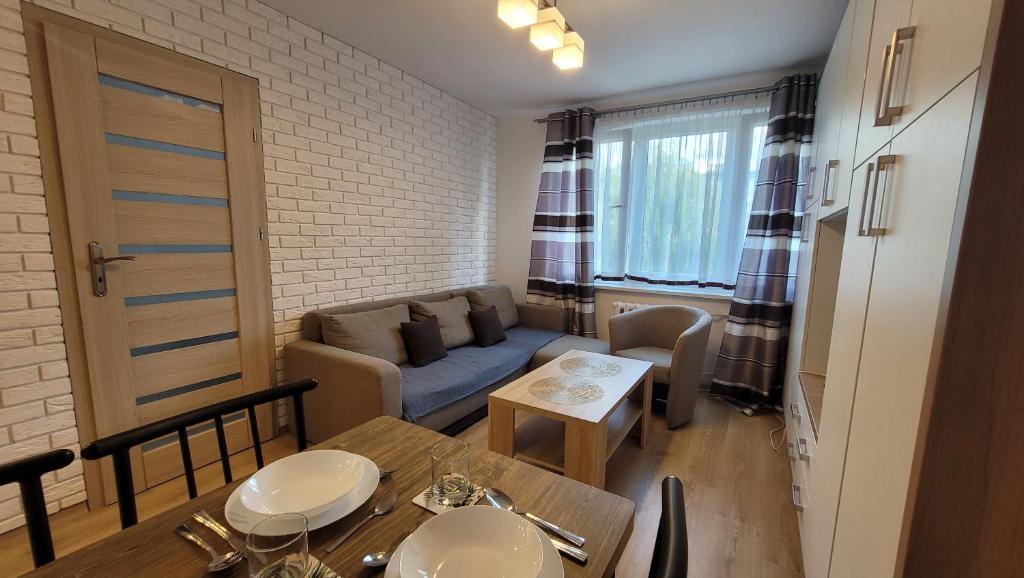 a small living room with a couch and a table at Apartament Alek Krosno in Krosno