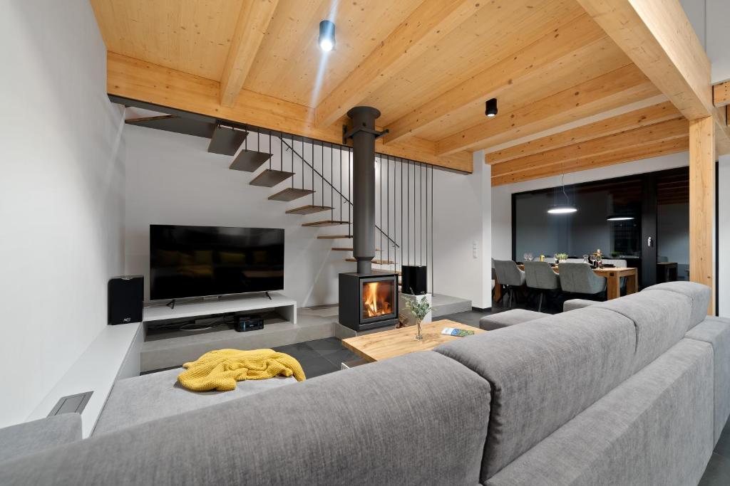 a living room with a couch and a fireplace at Vánice pod Klínovcem in Loučná pod Klínovcem