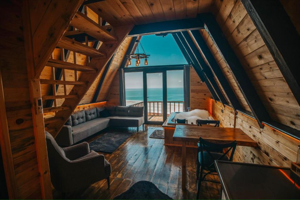 an attic room with a view of the ocean at Rova Suit Bungalov in Rize
