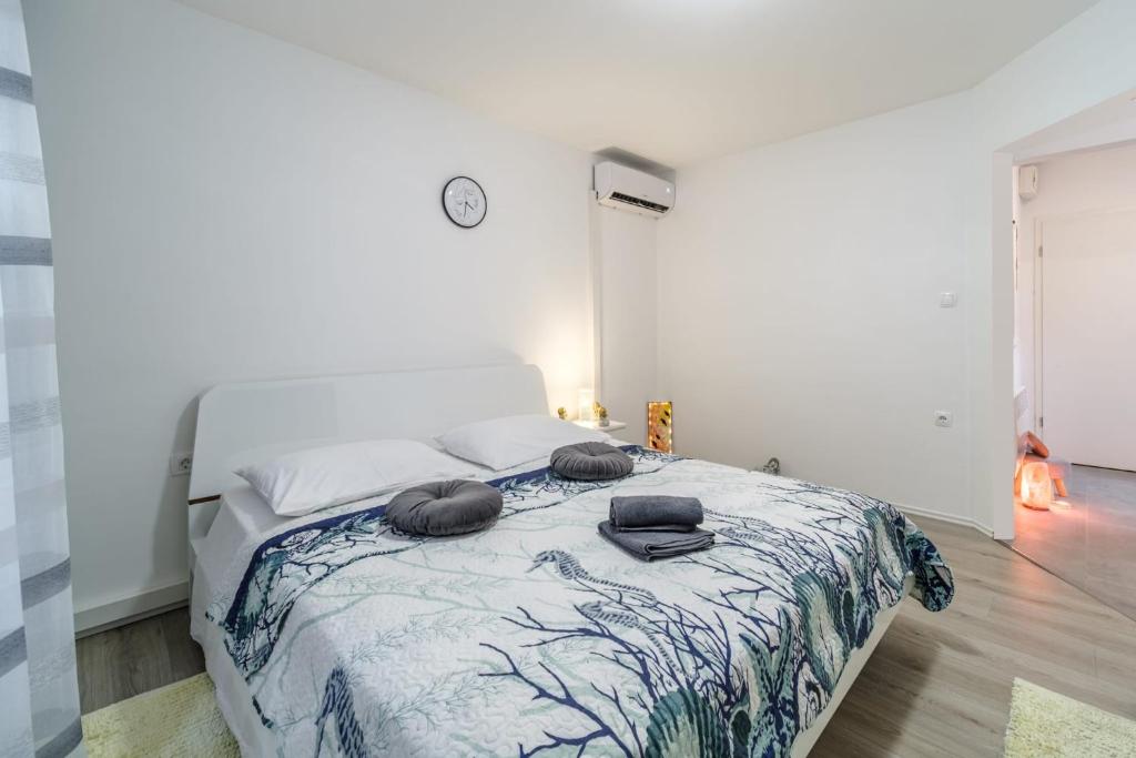 a bedroom with a bed with two pillows on it at Beautiful apartment Lena in Split