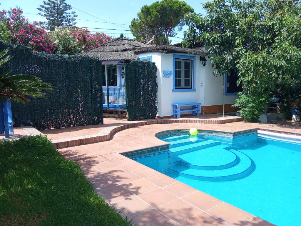a swimming pool with a tennis ball in a yard at Bungalow Marbella (San Pedro Alcantara) in Marbella