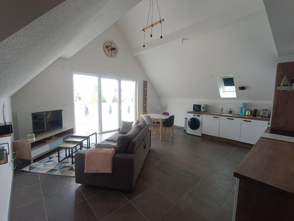 a large living room with a couch and a table at Au pied des champs - T2 50m2 au calme in Blaesheim