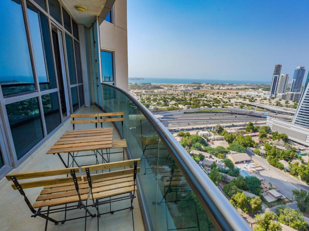 a balcony with two benches and a view of the city at 2 BHK @ Barsha Heights in Dubai