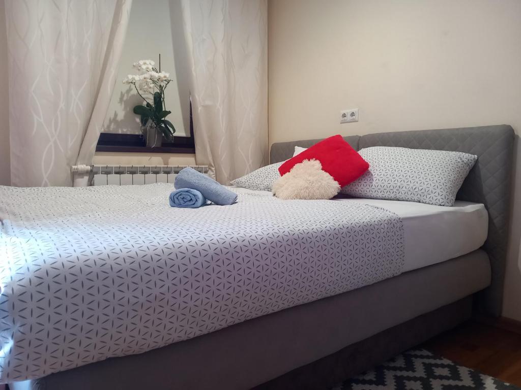 a bed with two stuffed animals on top of it at Apartman Gold City 2 Studio in Fojnica