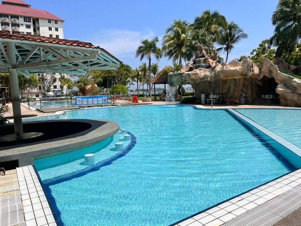 a swimming pool at a resort with a water park at Glory beach private PD in Port Dickson