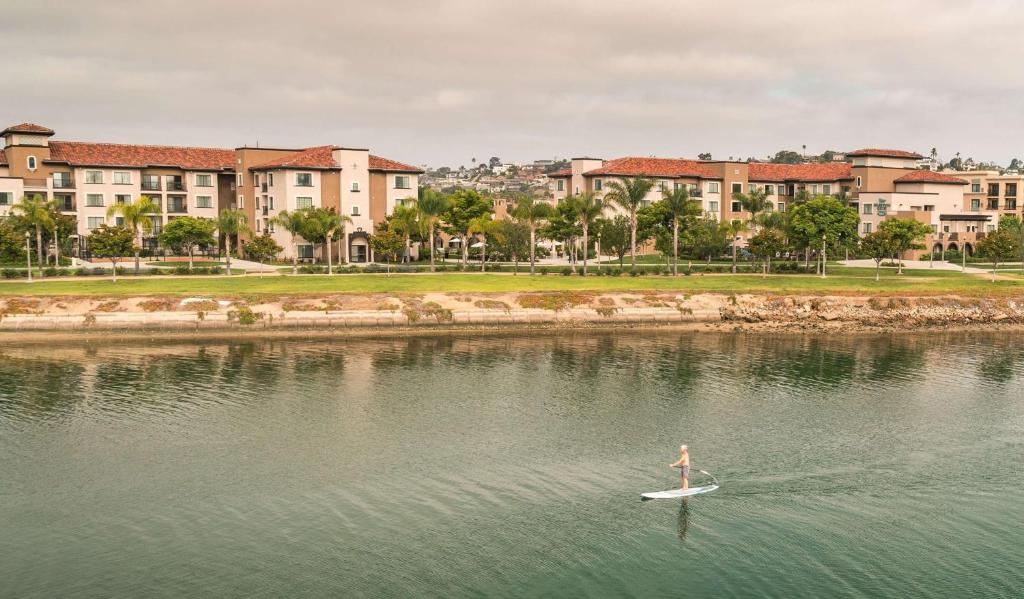a person on a paddle board in a body of water at Homewood Suites by Hilton San Diego Airport-Liberty Station in San Diego