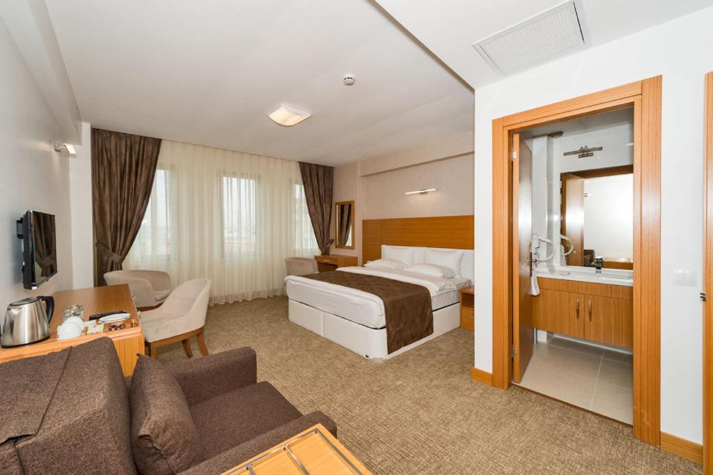 イスタンブールにあるMıen Hotelsのベッドとソファ付きのホテルルーム