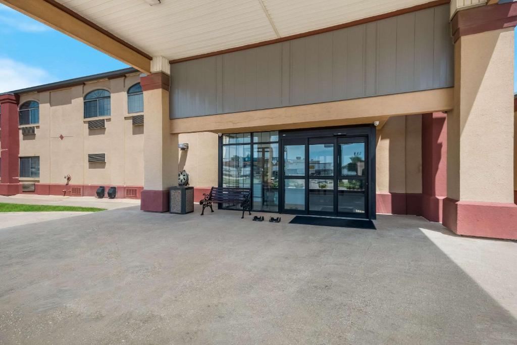 a building with a large glass door in front of it at Quality Inn & Suites Oklahoma City North in Edmond
