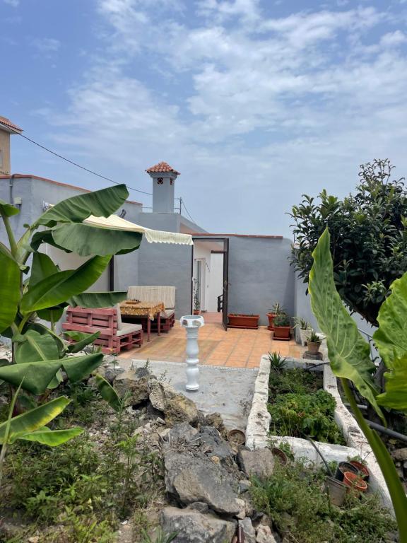 einen Hinterhof mit einer Terrasse und einem Haus in der Unterkunft Casas Asomada in Tanque