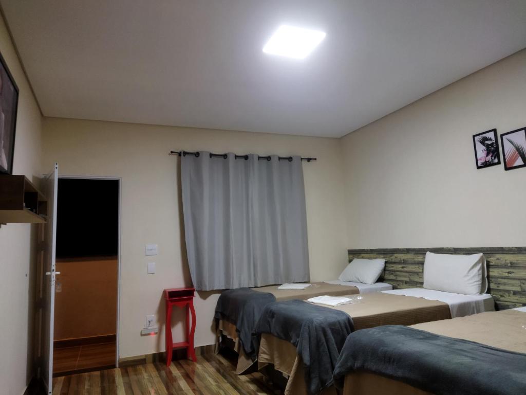 Postel nebo postele na pokoji v ubytování Pousada Morada dos Pássaros