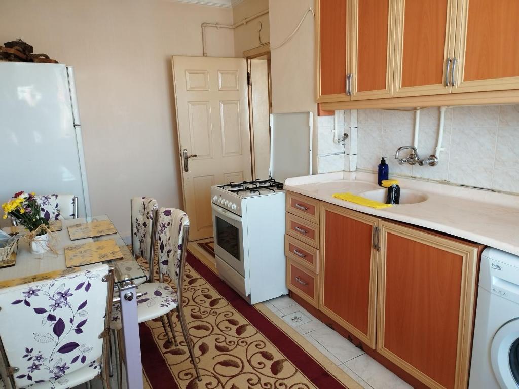 a kitchen with a sink and a stove top oven at hilal in Erzurum