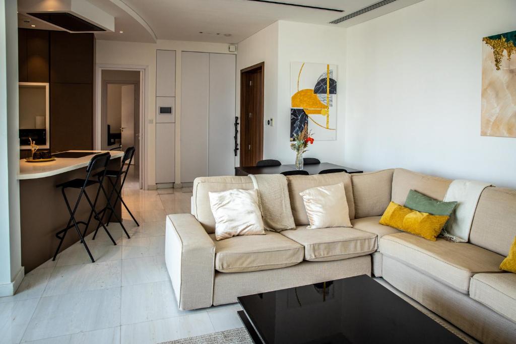 a living room with a couch and a table and a kitchen at Phaedrus Living: 360 Tower Luxury Flat in Nicosia