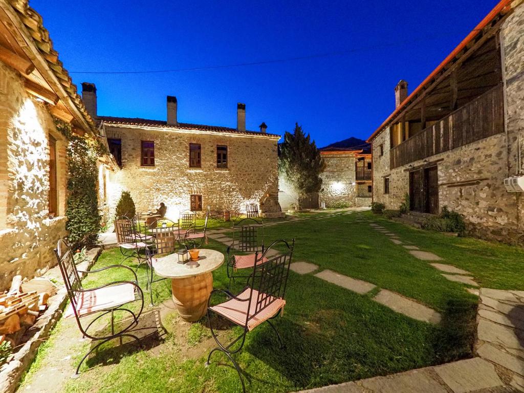 a patio with chairs and a table in a yard at Agios Germanos in Agios Germanos