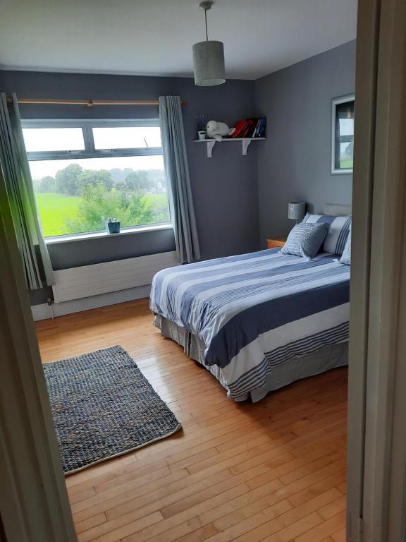 a bedroom with a bed and a large window at Butterhouse in Trim
