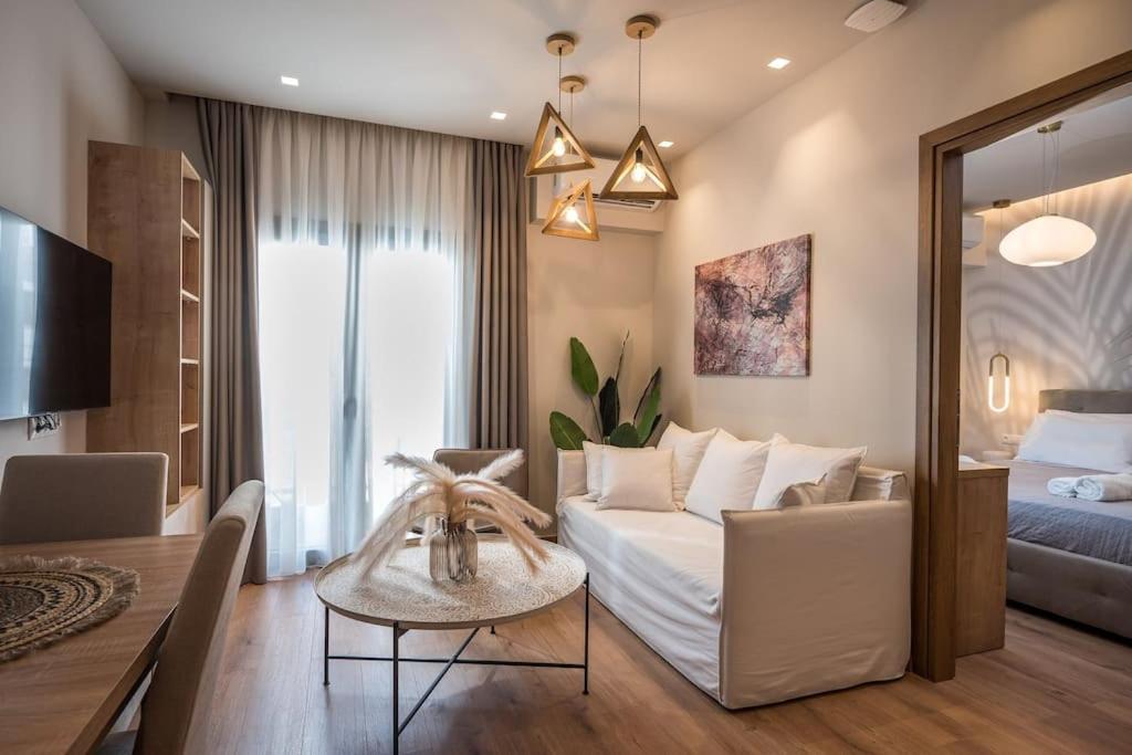 a living room with a bed and a table in a room at Amalia's Luxury Apartment 1 in Heraklio