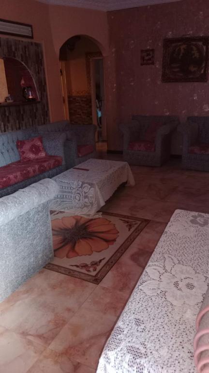 a room with two beds and a rug on the floor at شقة بڤيلا بالمنيا الجديده للايجار اليومي و الاسبوعي 