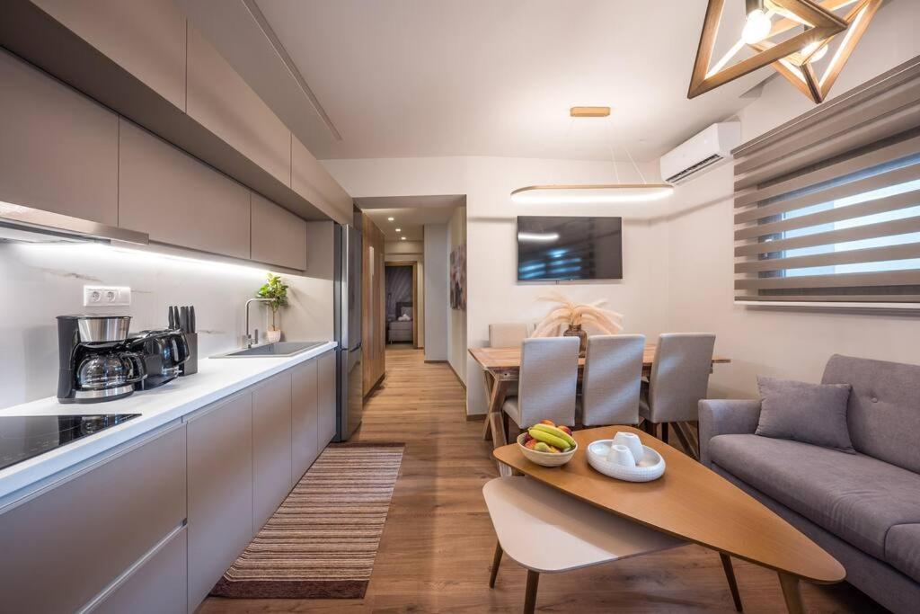 cocina y sala de estar con sofá y mesa en Amalia's Luxury Apartment 2, en Heraclión