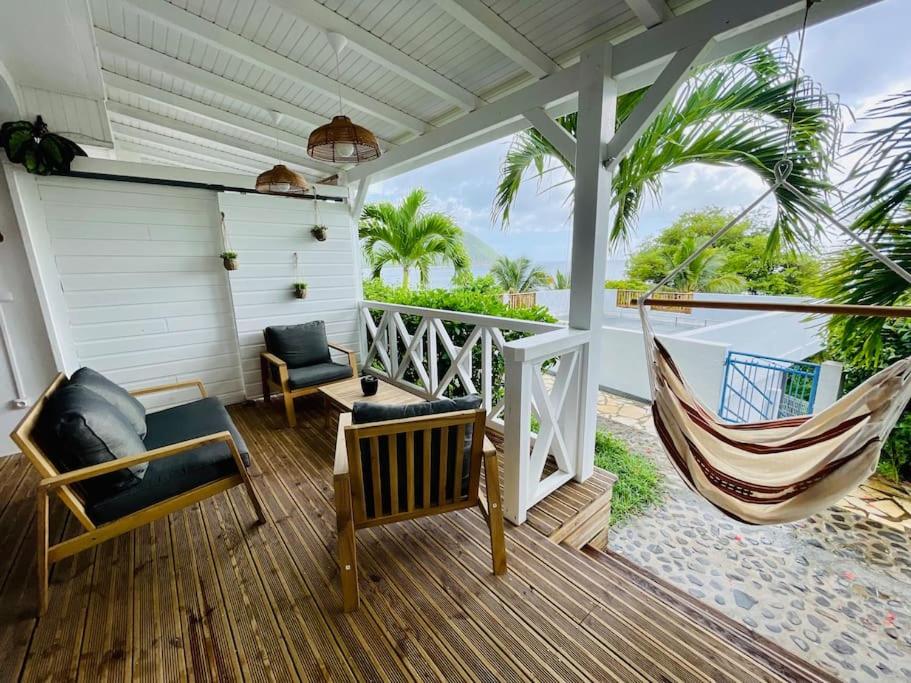 a porch with a hammock and a swing at La p’tite barque Antillaise in Deshaies