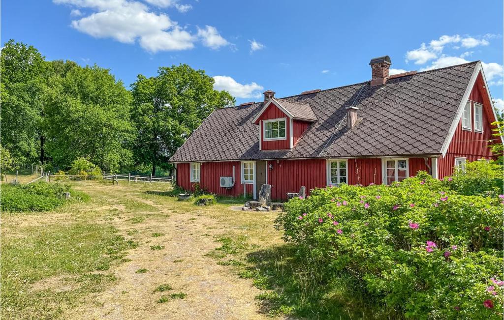 a red house with a black roof at Gorgeous Home In Vittsj With House A Panoramic View in Vittsjö