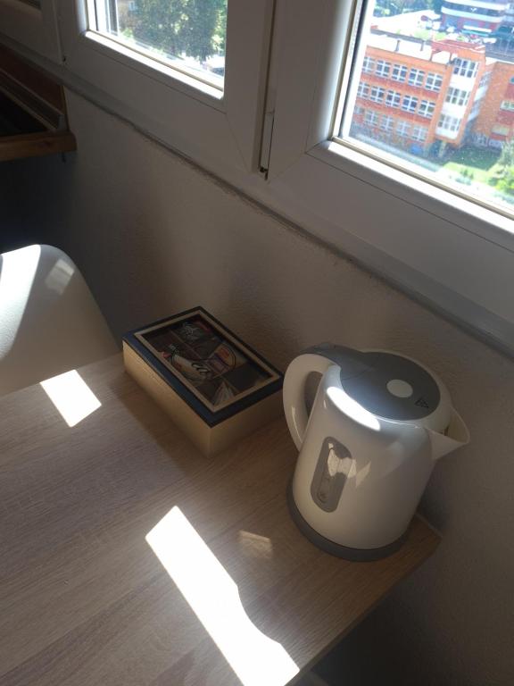 a pot sitting on the floor next to a window at Kineski zid in Zenica