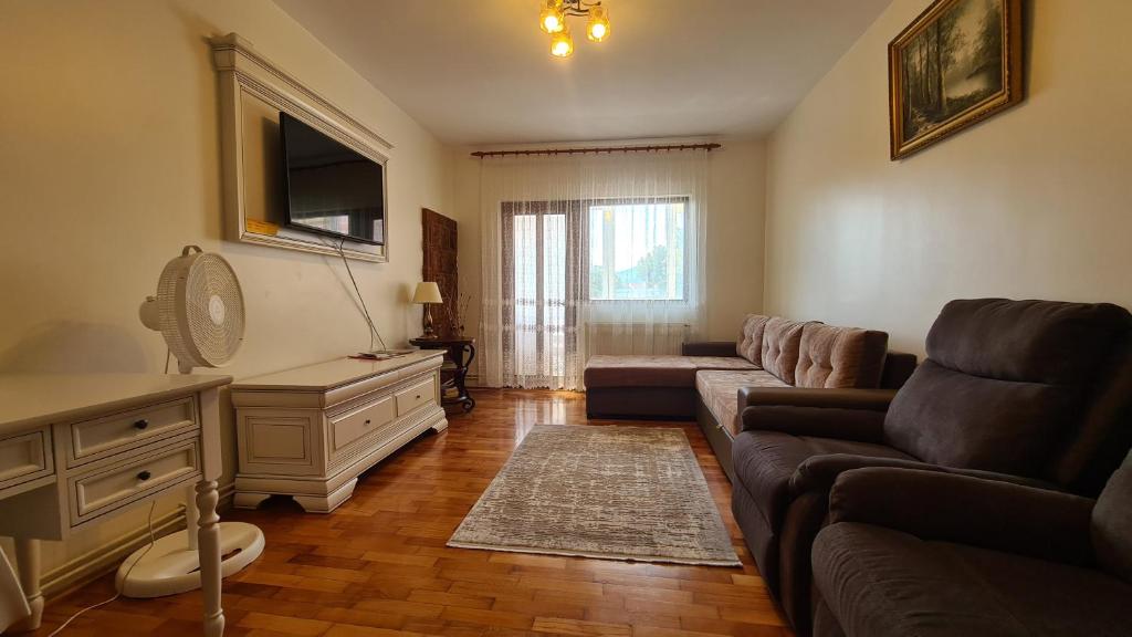 a living room with a couch and a table at Apartament Bogdan in Gura Humorului