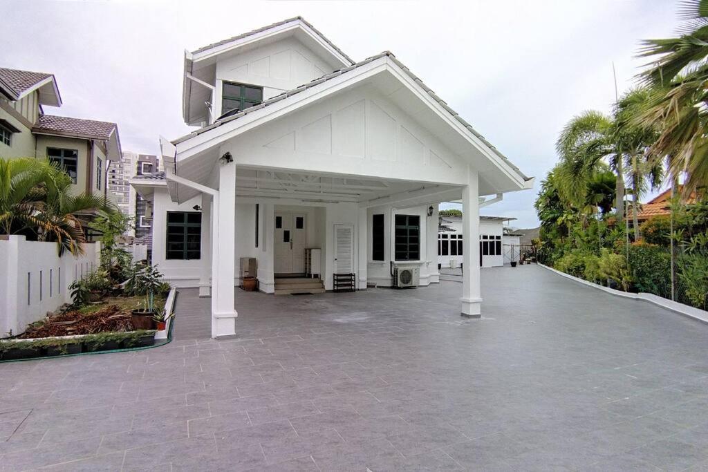 a white house with a large driveway at Forest Valley Homestay Bungalow for Family/Group Staycation/Gathering in Cheras