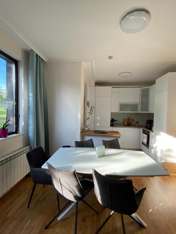 a kitchen and dining room with a table and chairs at Vacation house in Pravets golf resort At Pravets Lake in Pravets