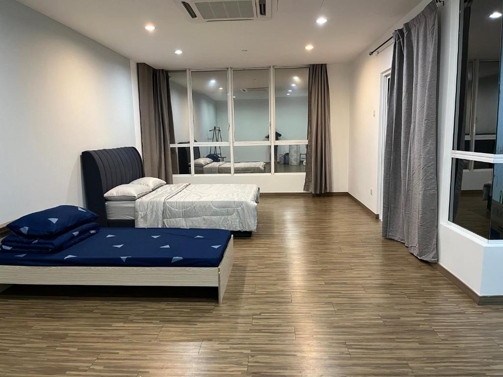 a hospital room with two beds and a mirror at Good Mood House 3-7pax,Free Parking,upstairs Shopping Mall, Hospital Columbia, TAR University, LRT Station in Kuala Lumpur